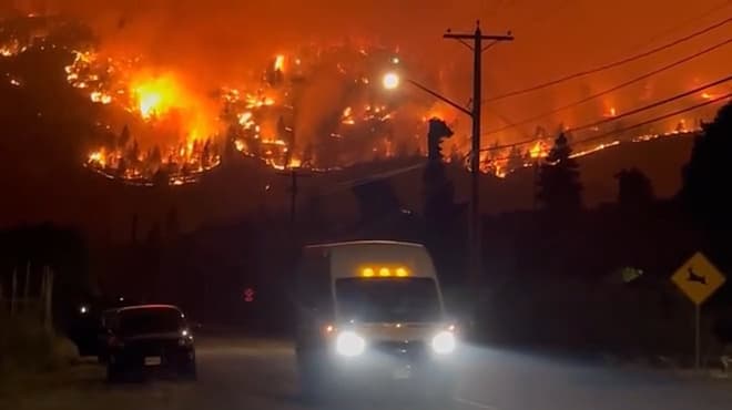 A fast-moving wildfire forces more than 20,000 people to evacuate in western Canada