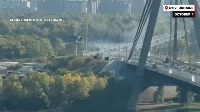 Russian drone slams into Kyiv bridge in escalating campaign as Germany’s chancellor arrives to airsirens and explosions