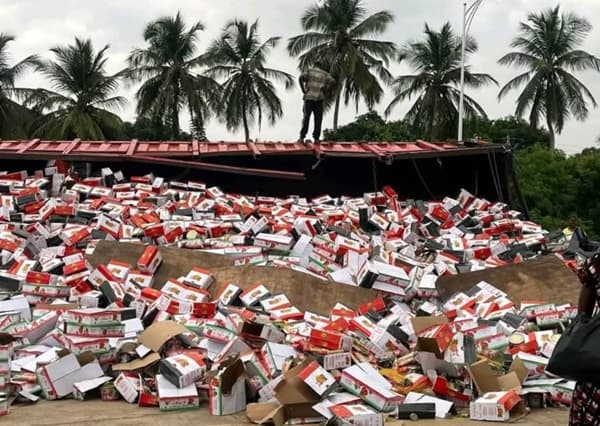 Articulated truck loaded with tomatoes and spaghetti overturns at Sokpoe