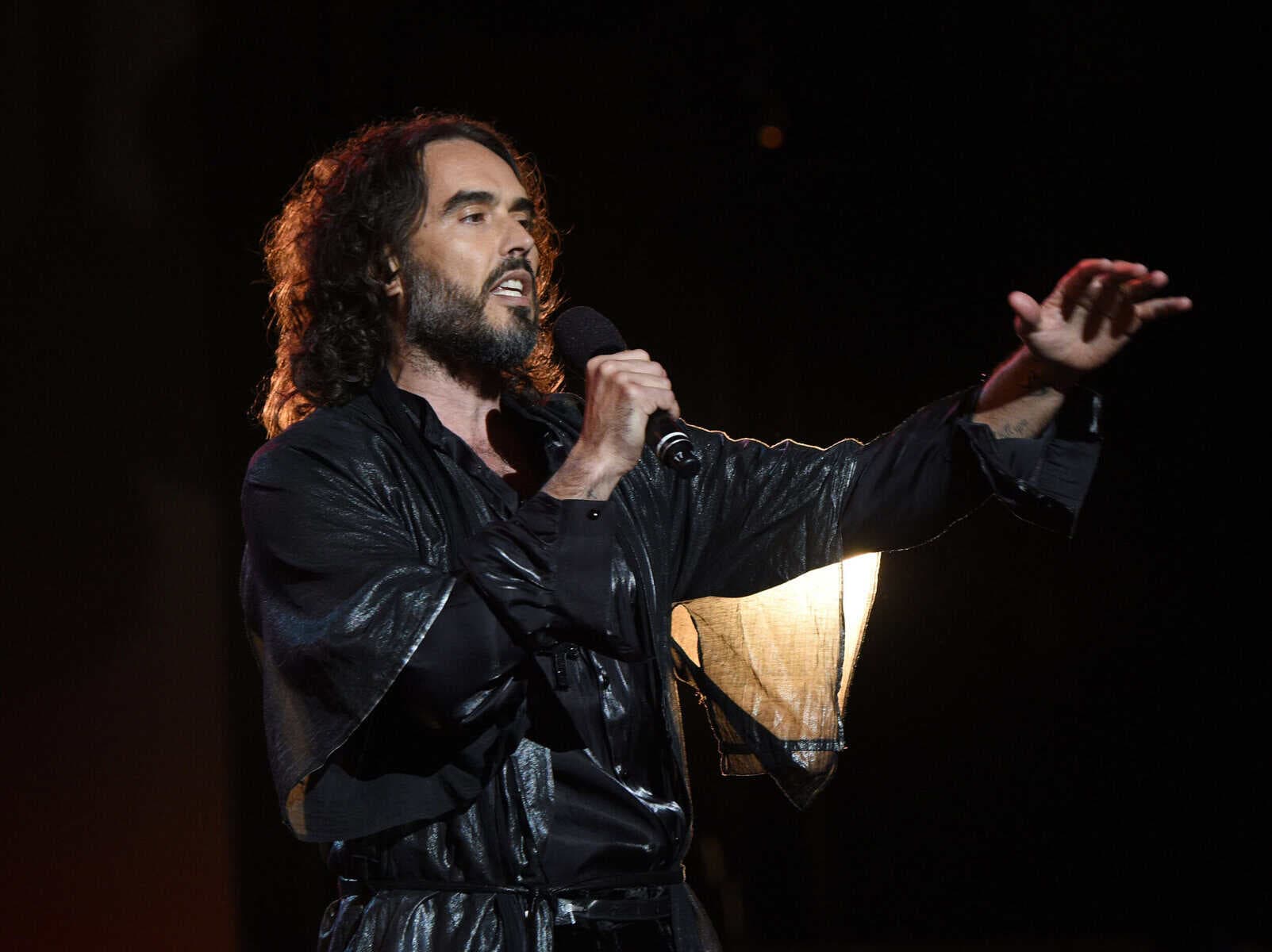 Comedian Russell Brand appears in UK court for start of rape trial