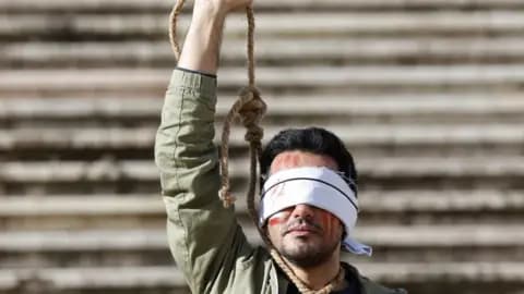 Iran announces execution of two protesters accused of setting police officers on fire