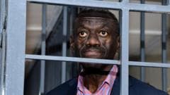Veteran Ugandan opposition politician collapses in court and is in ICU, his wife says
